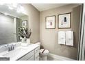 Modern bathroom with a sleek vanity, framed art, and a shower featuring contemporary gray tiling at 3351 Orwell Way # 2301, Cumming, GA 30041