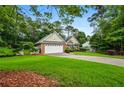 Charming single-Gathering home featuring a well-manicured lawn and a two-car garage at 3770 Wake Robin Way, Cumming, GA 30028