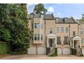 Charming townhome with brick facade, multiple dormers, and inviting front entrances at 92 Old Ivy Ne Rd # 6, Atlanta, GA 30342