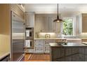 Bright kitchen featuring stainless steel appliances, white cabinetry, and a view from the window at 92 Old Ivy Ne Rd # 6, Atlanta, GA 30342