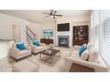 Bright, staged living room with fireplace, plush seating, and built-in bookcase at 252 Stone Park Dr, Woodstock, GA 30188