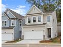 Charming two-story home featuring a white garage door, complemented by stone accents at 706 Smokey Quartz Way, Kennesaw, GA 30144