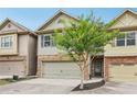 Charming townhome showcasing manicured landscaping and stone accents at 146 Sunset Ln, Woodstock, GA 30189