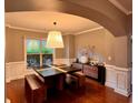 Elegant dining room featuring a unique dining table with bench seating and stylish decor at 2532 Gloster Mill Drive Southwest, Lawrenceville, GA 30044