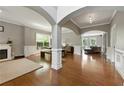 Spacious living room features archways, hardwood floors, fireplace and wainscoting, offering a bright and inviting space at 2532 Gloster Mill Drive Southwest, Lawrenceville, GA 30044