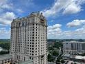 Beautiful high-rise building with blue skies and lush greenery in a park setting at 3040 Peachtree Nw Rd # 1713, Atlanta, GA 30305