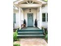 Inviting front porch with a charming door, decorative plants, and a cozy seating area at 3604 Orchard Cir, Decatur, GA 30032