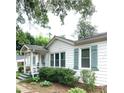 Well-maintained home exterior featuring a cozy front porch and neatly landscaped garden, painted shutters at 3604 Orchard Cir, Decatur, GA 30032