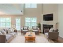 Bright and airy living room featuring a fireplace, high ceilings, and comfortable seating at 513 Shadow Valley Ct, Lithonia, GA 30058