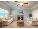 Bright living room with fireplace, ceiling fan, neutral paint, and a decorative rug and furniture at 5341 Terrytown Ln, Lithonia, GA 30038