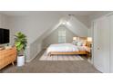 Serene bedroom with a sloped ceiling, neutral colors, and a minimalist design at 901 Chadwick Park Dr, Lawrenceville, GA 30045