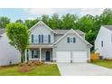 Charming two-story home with a well-manicured lawn, a two car garage, and inviting curb appeal at 334 Bloomfield Cir, Canton, GA 30114