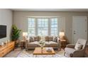 Bright living room with neutral tones, large windows, and stylish furniture at 5207 Shawn Ln, Stone Mountain, GA 30088