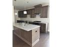 Modern kitchen featuring an island with granite counters, pendant lighting, and stainless steel appliances at 1250 Winterhaven Dr, Cumming, GA 30041
