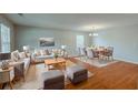 Open concept living room and dining area with stylish furniture, hardwood floors, and plenty of space for entertaining at 440 Pinevale Ct, Atlanta, GA 30349