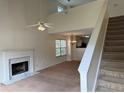 Bright living room featuring a marble fireplace, staircase and open-concept design to dining and kitchen at 133 Magazine St, Dallas, GA 30157