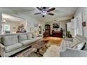 Inviting living room with hardwood floors, a ceiling fan, and comfortable seating for relaxation and entertaining at 3229 Richwood Dr, Duluth, GA 30096