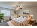 Serene main bedroom featuring a modern bed, soft lighting, dresser and large windows with natural light at 6200 Beaver Creek Trl, Atlanta, GA 30349