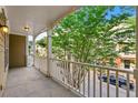 Balcony with white railing overlooking manicured landscaping with mature trees at 213 Riverstone Commons Cir, Canton, GA 30114