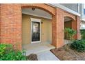 Townhome entryway with brick accents and a black front door and manicured landscaping at 213 Riverstone Commons Cir, Canton, GA 30114