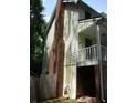 Side exterior view of a house with a brick chimney and a small balcony at 340 Sherwood Se Cir, Conyers, GA 30094