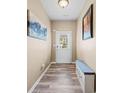 Bright foyer features wood floors, a front door with window, bench, and stylish decor at 44 Providence Oak Ct, Lawrenceville, GA 30046