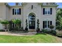 Charming front entrance features a stone path, manicured landscaping, and a welcoming doorway at 5245 Cottage Farm Rd, Johns Creek, GA 30022