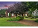 View of a beautiful two story brick home with manicured lawn and landscape in an idyllic setting at 4653 Glory Maple Trce, Powder Springs, GA 30127