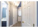 Bright hallway with a half bathroom, wood floors, and neutral paint at 6726 Gallant Se Ct # 30, Mableton, GA 30126