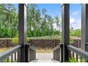 Beautiful outdoor view from porch shows trees, lush landscaping, and a privacy fence at 908 Catamaran Ct, Alpharetta, GA 30005