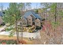 Breathtaking aerial view of a beautiful home with lush landscaping, a long driveway, and stunning curb appeal at 11180 West Rd, Roswell, GA 30075
