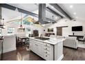 Open concept kitchen and living room with large island, pendant lights, and vaulted ceilings at 225 Jayne Ellen Way, Alpharetta, GA 30009