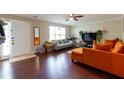 Bright living room with hardwood floors, ceiling fan, and cozy seating at 2545 Lake Royale Dr, Riverdale, GA 30296