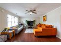 Comfortable living room with hardwood floors, ceiling fan, and gray and orange furniture at 2545 Lake Royale Dr, Riverdale, GA 30296