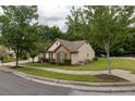 Well-manicured lawn and landscaping surround the home, complemented by mature trees and shrubbery at 1889 Raegan Way, Lawrenceville, GA 30043