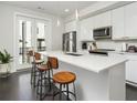 Modern kitchen boasts a large island with seating, sleek white cabinets, and stainless appliances at 415 Gartrell Se St # 16, Atlanta, GA 30312