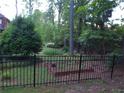 A fenced in backyard with a garden and an abundance of mature landscaping at 5741 Wolf Laurel Ln, Lilburn, GA 30047