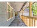 Spacious covered porch with wood railing, offering an inviting outdoor space at 7074 Babbling Brook Dr, Jonesboro, GA 30236