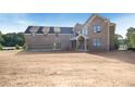 Spacious brick home with a three-car garage, dormers and covered front entry at 2395 Kilgore Road (Lot 7) Rd, Buford, GA 30519