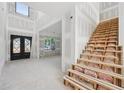 Foyer area showcasing stairs, and a black double door entrance for an elegant arrival at 2395 Kilgore Road (Lot 7) Rd, Buford, GA 30519
