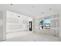 Living room with a large window and black front entry door, ready to be customized at 2395 Kilgore Road (Lot 7) Rd, Buford, GA 30519