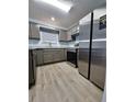 Stylish kitchen features stainless steel appliances, granite countertops, wood-look floors, and natural light at 5538 Pineridge Ct, Forest Park, GA 30297