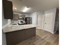 Bright kitchen features updated granite counters, stainless steel appliances, and modern wood-look flooring at 5538 Pineridge Ct, Forest Park, GA 30297