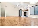 Bright living room featuring a stone fireplace, hardwood floors, and large windows at 468 Watson Ferry Dr, Forest Park, GA 30297