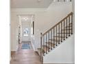 Bright foyer with staircase and wood floors, leading to the front door at 146 Silver Leaf Trce, Douglasville, GA 30134