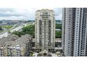 An impressive aerial view showcasing the condo high-rise against a cityscape backdrop and highway at 795 Hammond Dr # 503, Sandy Springs, GA 30328