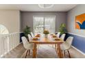 Dining room with natural light, modern dining set, neutral walls, and decor at 1006 Eagle Vw, Lawrenceville, GA 30044