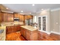 Gourmet kitchen with custom cabinets, granite countertops, stainless steel appliances, and hardwood flooring at 2458 Brook Park Trl, Snellville, GA 30078