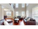 Open floor plan living room showcasing hardwood floors and large windows at 2458 Brook Park Trl, Snellville, GA 30078