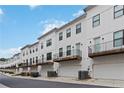 Row of townhomes with garage, each featuring a private balcony, enhancing outdoor living space and curb appeal at 2461 Sycamore Nw Rd, Atlanta, GA 30318
